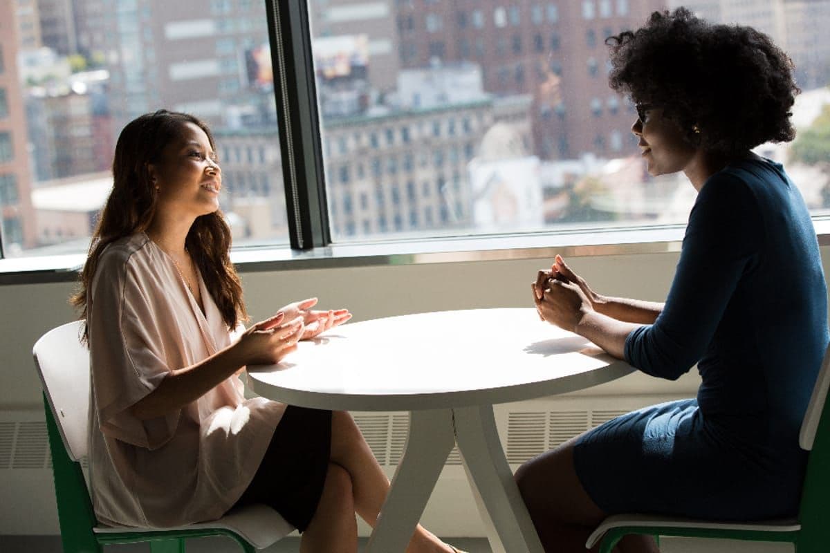 Two colleagues in discussion at a table